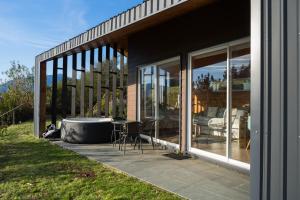 a screened in porch with a bath tub on a house at Petricor Ecolodge Cab2 in Pucón