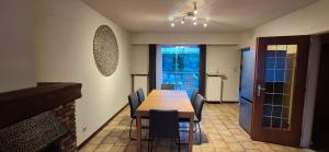 a dining room with a wooden table and chairs at CoSY HOME in Mortsel