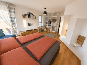 a bedroom with a bed with orange pillows on it at Luxury Villa Vienna in Mauerbach
