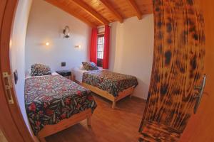 a small room with two beds and a mirror at Casa La Tabona in Frontera