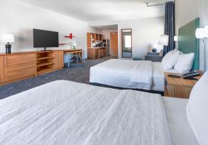 a hotel room with two beds and a flat screen tv at Home2 Suites By Hilton Carson City in Carson City +52 photos