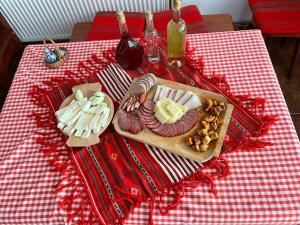 a table with a tray of cheese and meats and other foods at Cabana Carolina in Laz