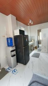 a kitchen with a black refrigerator in a room at Engil's Studio in San Jose Dinagat Islands Philippines in Bulawan