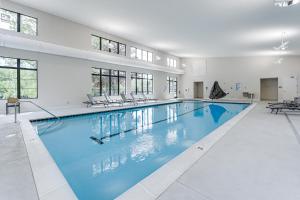 a large swimming pool with blue water in a building at Only 8/22-8/29 Still Available for Summer 2026! in Harbor Springs