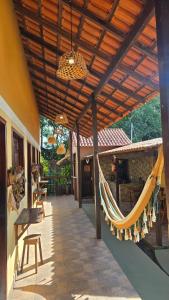 a porch with a hammock hanging from a building at Vila Rudá - Alter do Chão in Alter do Chao