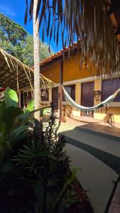 a house with a hammock in front of it at Vila Rudá - Alter do Chão in Alter do Chao