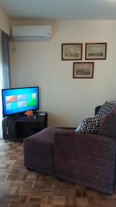 a living room with a couch and a flat screen tv at Marazul in Montevideo