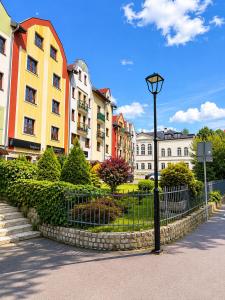 a street light in front of a row of buildings at Kopernik Loft Jelenia Góra in Jelenia Góra