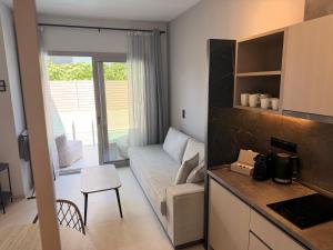 a kitchen and living room with a couch and a table at LaK Private Pool Suites in Potos,Thassos in Potos