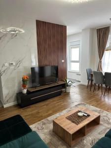 a living room with a flat screen tv at New Bubanj Apartment 3 in Kragujevac