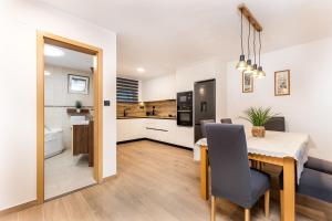 a kitchen and dining room with a table and chairs at Villa Michelle in Pakoštane