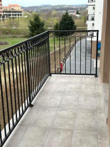 a balcony with a black railing with a view of the water at New Bubanj Apartment 3 in Kragujevac