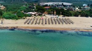 an aerial view of a beach with chairs and umbrellas at Seven Plus in Filiatra