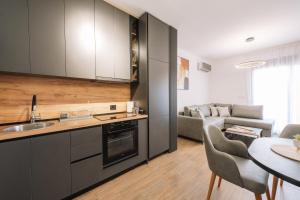 a kitchen and living room with a table and a couch at Stanovic Bungalow in Ulcinj