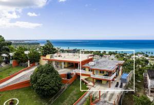 an aerial view of a house with the ocean in the background at Villa Marbella - Ocean Views & Private Pool in Luquillo