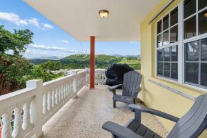 a house with two chairs on a balcony at Villa Marbella - Ocean Views & Private Pool in Luquillo +23 photos
