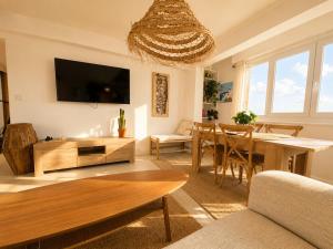 a living room with a table and a dining room at Downtown Terrace with panoramic view in Tourcoing