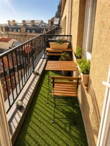 a balcony with benches and plants on a building at Downtown Terrace with panoramic view in Tourcoing