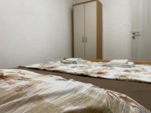 two beds in a room with a mirror at Rena Comfort Apartment in Bar