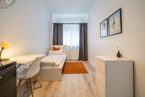 a small room with a bed and a desk at D10 I shared bathrooms&kitchen in Garching bei München