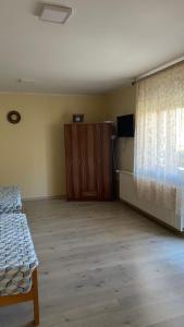 an empty room with a bed and a window at Djurdja Apartment in Arandelovac