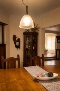 a dining room table with a plate of food on it at Caelum House Familiar Con Cochera in Rafaela +18 photos