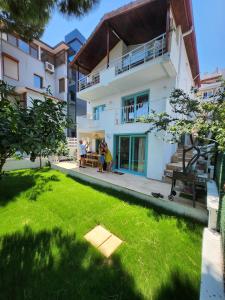 a group of people standing in front of a house at Nunu HOUSE Urla in Urla