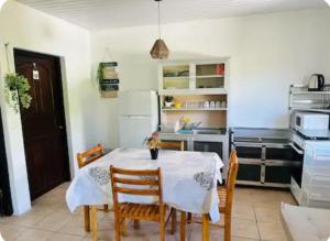 a kitchen with a table and chairs in a kitchen at F2 Tahiti Lagoon Stays in Punaauia