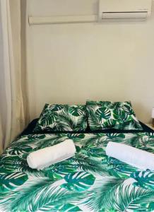 a bed with two pillows on it in a room at F2 Tahiti Lagoon Stays in Punaauia