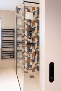 a shower in a bathroom with a glass door at Lichti´s Rooms & Appartements in Aspang Markt +46 photos