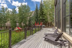 a deck with two chairs and a fence at Pines #2163 in Keystone