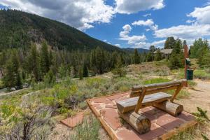 a wooden bench sitting on top of a field at Pines #2163 in Keystone +45 photos
