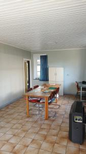 a living room with a wooden table and chairs at Rombaut Restout in Lokeren