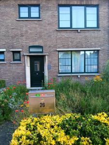 a house with a sign in front of a building at Rombaut Restout in Lokeren