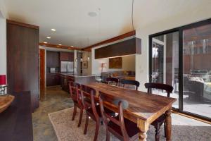 a kitchen and dining room with a wooden table and chairs at Belmont Beauty in Ketchum