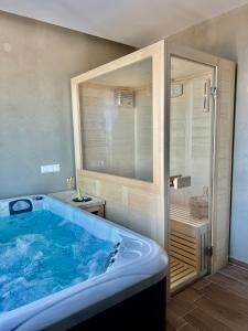 a large tub in a bathroom with a shower at Nayra View & Spa in Kavála +46 photos