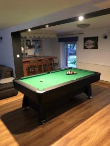 a billiard table in a living room with afits at Żurawie Wzgórze in Mrągowo