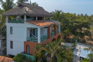 a small building with a thatch roof on top at Casa Guadalupe - big beach oasis! in Brisas de Zicatela