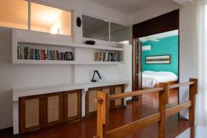 a room with a staircase and a room with a bed at Casa Guadalupe - big beach oasis! in Brisas de Zicatela