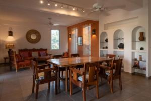 a dining room with a wooden table and chairs at Casa Guadalupe - big beach oasis! in Brisas de Zicatela