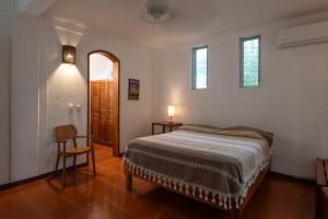 a bedroom with a bed and a table and a chair at Casa Guadalupe - big beach oasis! in Brisas de Zicatela +34 photos