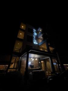 a building with a sign on it at night at Hotel Utopia in Ksamil