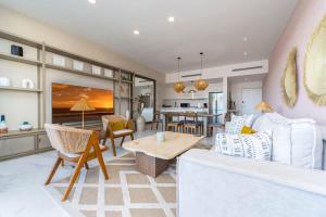 a living room with a couch and a table at 3BR Apartment Beach & Dining Steps Away in Cabo San Lucas