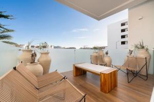 a living room with a table and chairs and vases at 3BR Apartment Beach & Dining Steps Away in Cabo San Lucas +30 photos