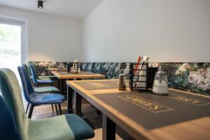a row of tables in a restaurant with blue chairs at Lichti´s Rooms & Appartements in Aspang Markt