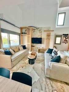 a living room with two couches and a table at Artion Jacuzzi Villa Nikiti in Nikiti