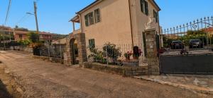 a building with a gate on the side of a street at sunset suite con terrazza e barbecue in Imperia