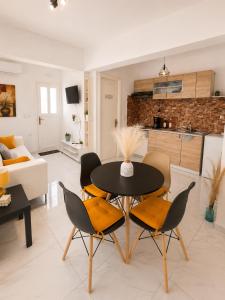 a kitchen and living room with a table and chairs at 4T apartments in Argostoli