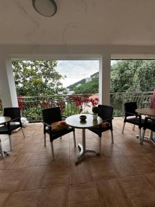 a room with a table and chairs and a balcony at Villa primorka in Boreti +21 photos