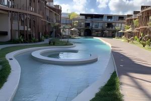 a swimming pool in the middle of a courtyard at Condo with Beach Access By MME in Tatuamunha